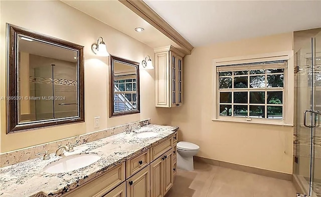 bathroom with tile patterned floors, vanity, toilet, and walk in shower