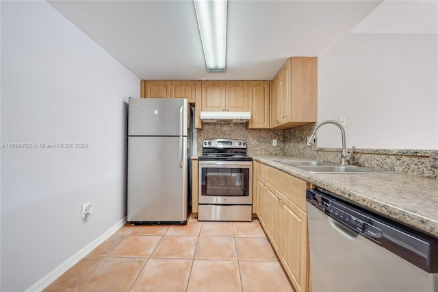 kitchen featuring sink, stainless steel appliances, decorative backsplash, light brown cabinetry, and light tile patterned floors