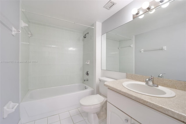 full bathroom featuring tile patterned floors, vanity, toilet, and tiled shower / bath combo