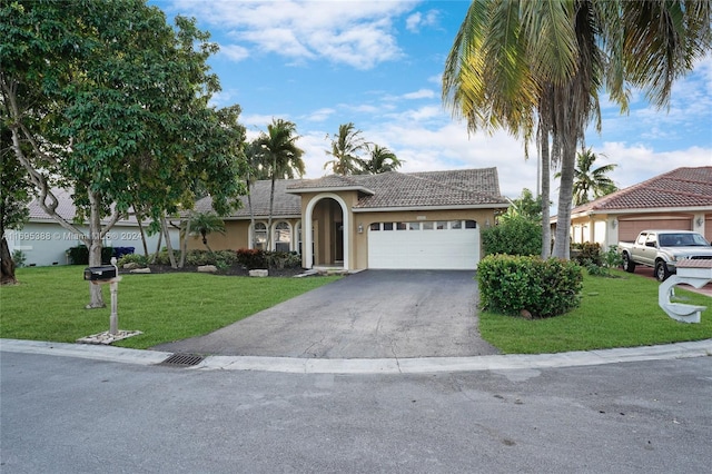 view of front of house with a front yard and a garage