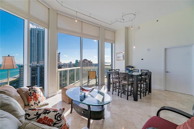 living room featuring floor to ceiling windows and a water view