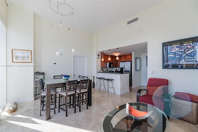 dining space featuring a high ceiling