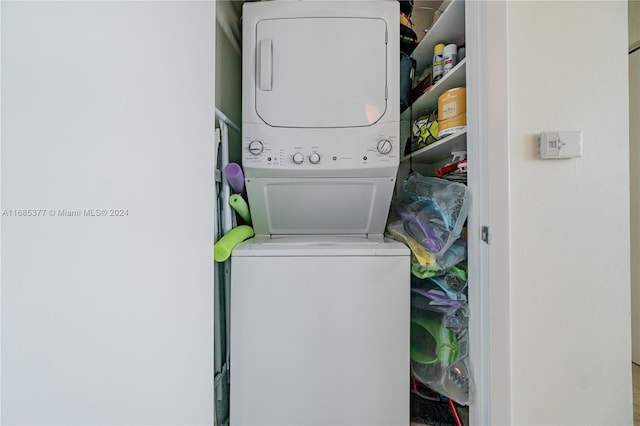 washroom featuring stacked washer / drying machine