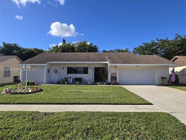 ranch-style house featuring a front yard and a garage