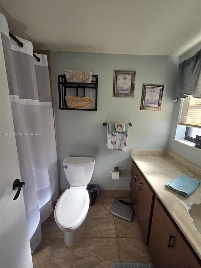 bathroom featuring vanity, tile patterned floors, and toilet