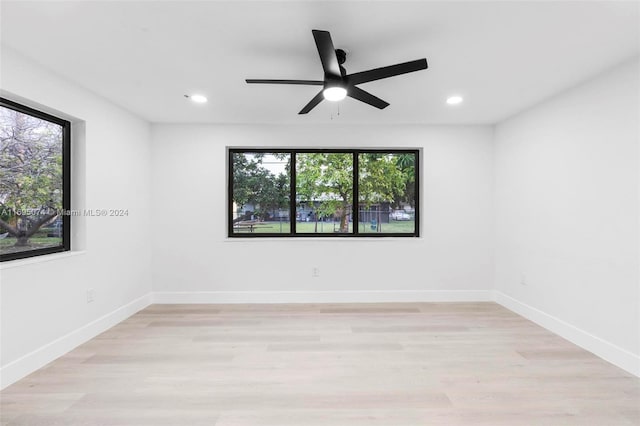 unfurnished room featuring ceiling fan, a healthy amount of sunlight, and light hardwood / wood-style floors