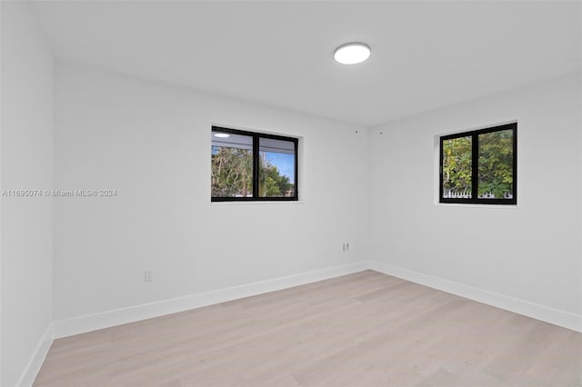 unfurnished room featuring a healthy amount of sunlight and light hardwood / wood-style flooring