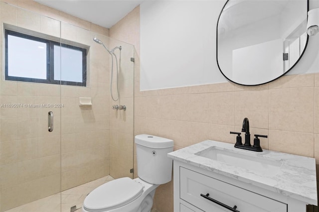 bathroom featuring vanity, backsplash, toilet, tile walls, and an enclosed shower