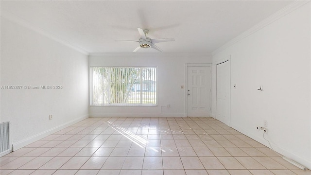 tiled empty room with ceiling fan and crown molding