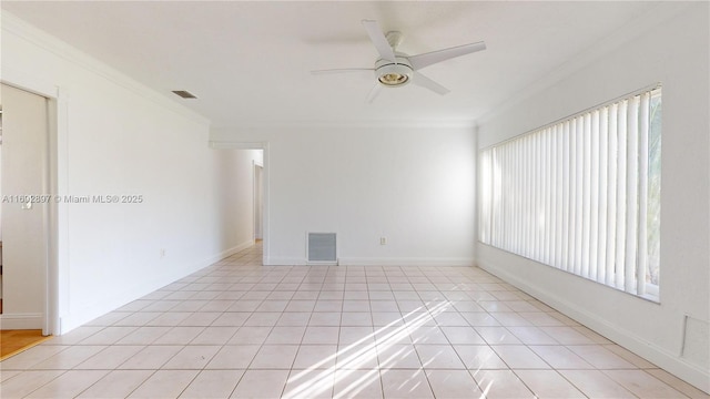 tiled spare room with ceiling fan and crown molding