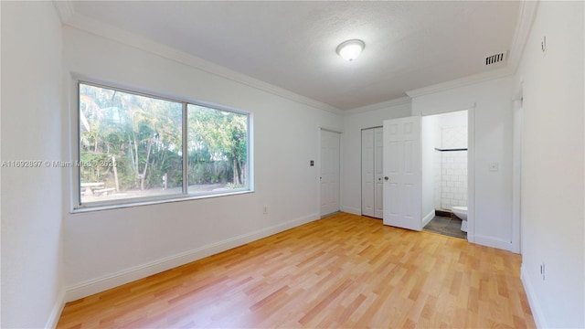 unfurnished bedroom featuring light hardwood / wood-style flooring and crown molding