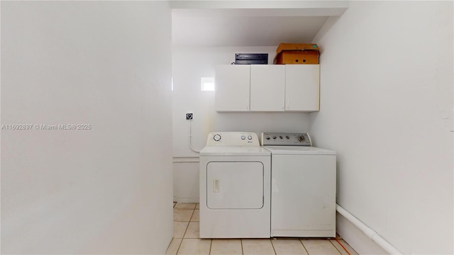 laundry area with cabinets, independent washer and dryer, and light tile patterned floors