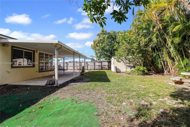 view of yard featuring a shed and a patio area