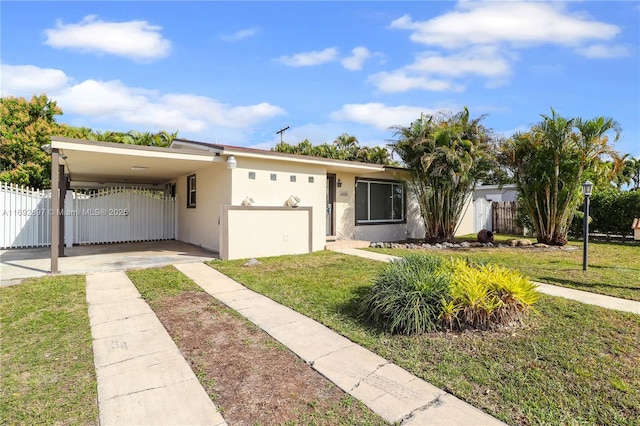 ranch-style house with a carport and a front yard