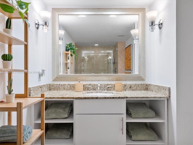 bathroom featuring vanity and a shower with door