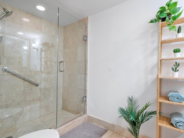 bathroom with toilet, tile patterned floors, and an enclosed shower