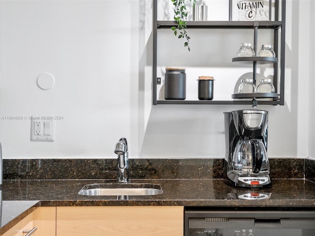 kitchen with dishwasher, light brown cabinets, and sink