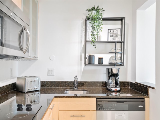 kitchen with light brown cabinets, stainless steel appliances, and sink