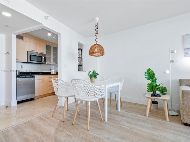 dining area featuring light wood-type flooring