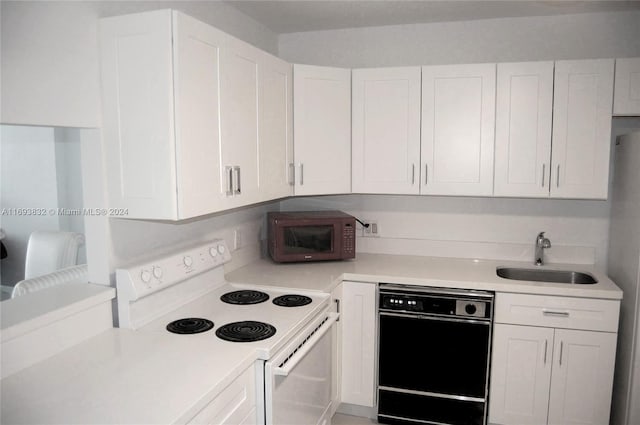 kitchen featuring white cabinets, sink, and black appliances