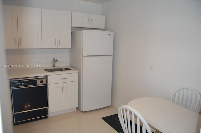 kitchen with sink, dishwasher, white cabinets, and white refrigerator