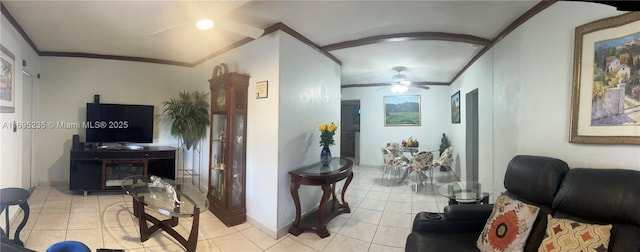 living room with ceiling fan, light tile patterned flooring, and ornamental molding