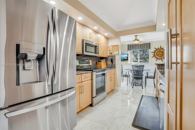 kitchen featuring ceiling fan, tasteful backsplash, light brown cabinetry, appliances with stainless steel finishes, and ornamental molding