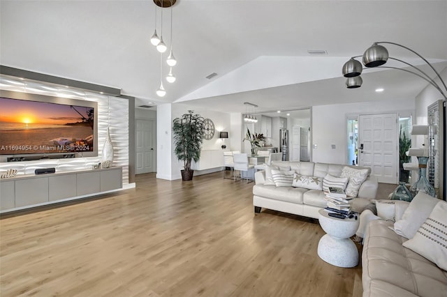 living room with hardwood / wood-style floors and lofted ceiling