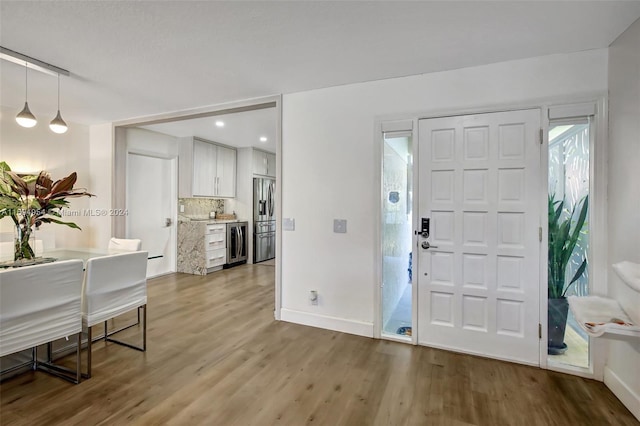 entrance foyer with wine cooler and hardwood / wood-style flooring