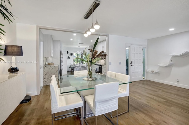 dining space with wood-type flooring