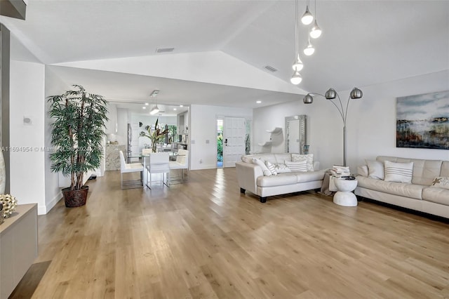 living room featuring light hardwood / wood-style floors and vaulted ceiling