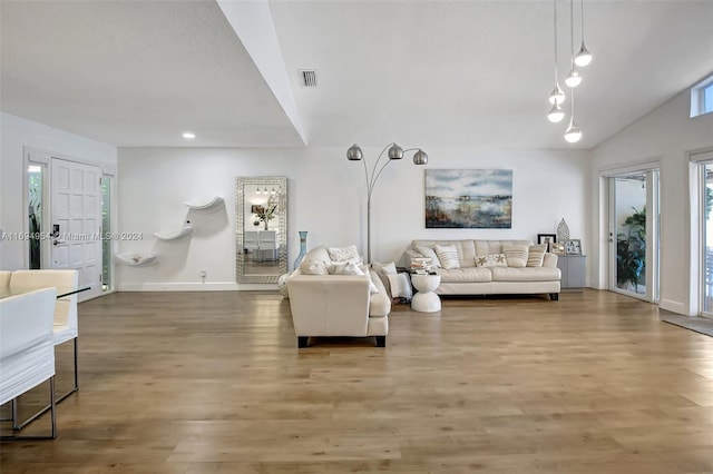 living room featuring hardwood / wood-style flooring and vaulted ceiling