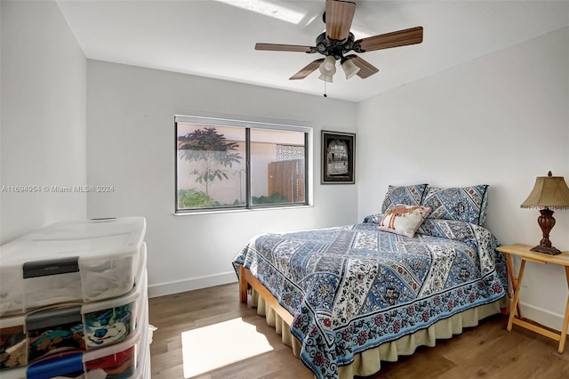 bedroom with hardwood / wood-style floors and ceiling fan