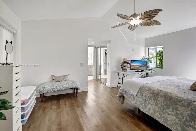 bedroom with hardwood / wood-style floors, ensuite bathroom, vaulted ceiling, and ceiling fan