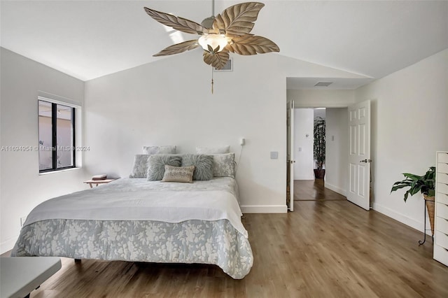 bedroom with ceiling fan, wood-type flooring, and lofted ceiling