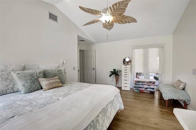 bedroom with dark hardwood / wood-style floors, vaulted ceiling, and ceiling fan