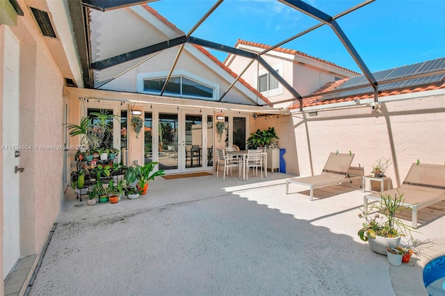 view of patio / terrace featuring glass enclosure and french doors