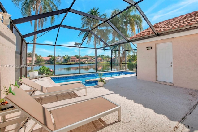 view of pool with a patio, a water view, and glass enclosure