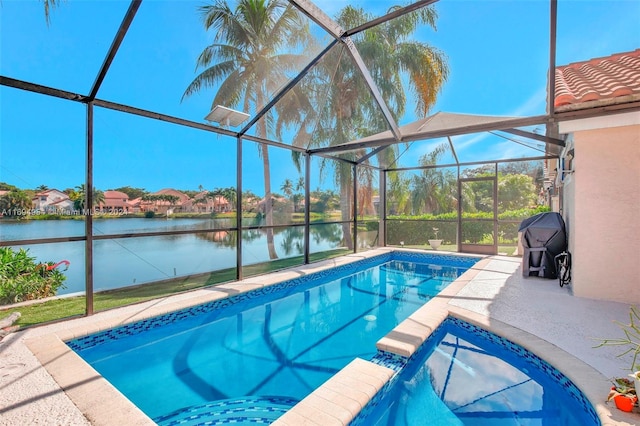 view of pool with a lanai, a patio area, and a water view