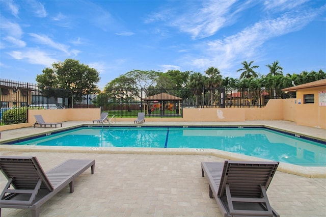 view of swimming pool with a patio