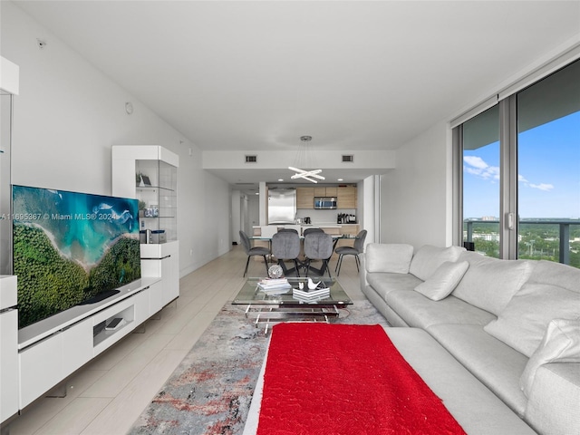 16385 Biscayne Blvd Unit 1615, North Miami Beach, FL 33160 - living room featuring a wall of windows and a chandelier