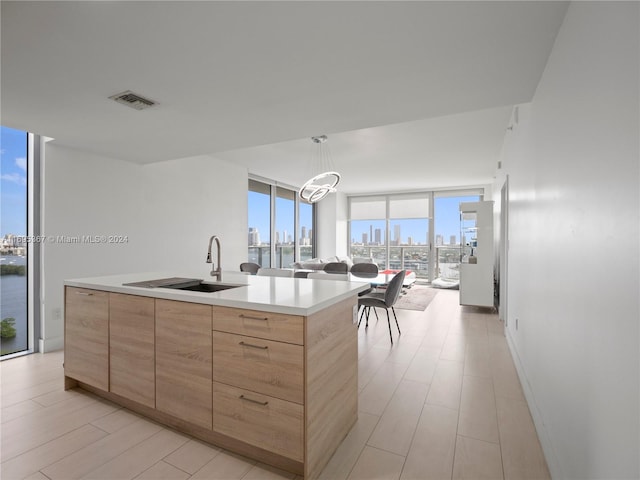 16385 Biscayne Blvd Unit 1615, North Miami Beach, FL 33160 - kitchen featuring light brown cabinetry, floor to ceiling windows, modern cabinets, a view of skyline, and light countertops