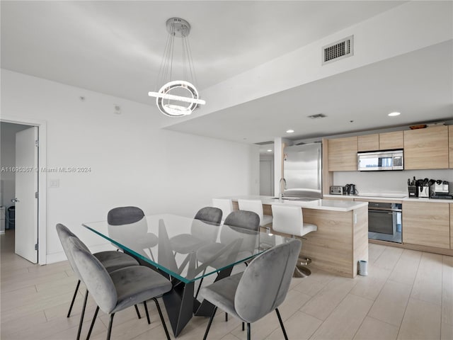 dining room featuring light hardwood / wood-style flooring and an inviting chandelier