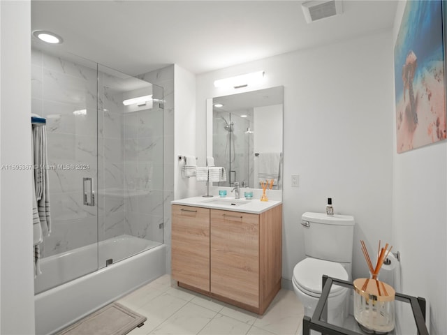 full bathroom featuring vanity, enclosed tub / shower combo, and toilet