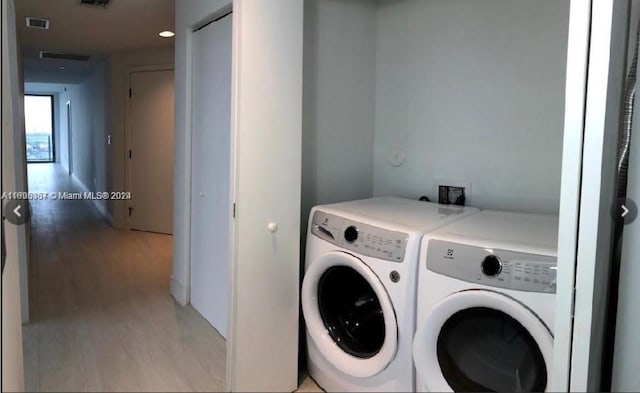 16385 Biscayne Blvd Unit 1615, North Miami Beach, FL 33160 - laundry area with separate washer and dryer and light wood-style flooring
