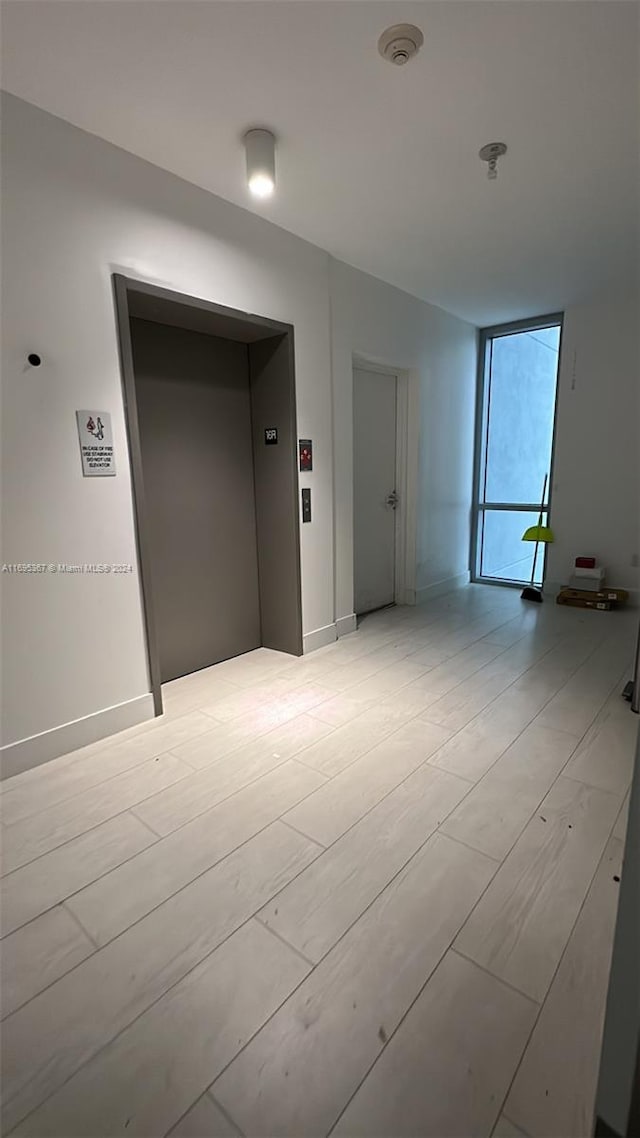 unfurnished room with elevator