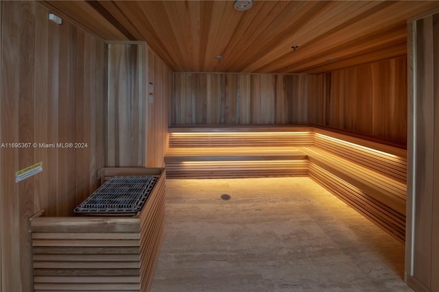 view of sauna featuring wooden ceiling and wooden walls