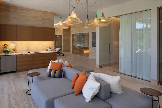 living room featuring sink and light hardwood / wood-style floors