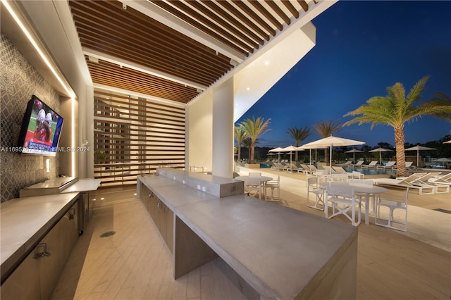 16385 Biscayne Blvd Unit 1615, North Miami Beach, FL 33160 - patio at night with an outdoor kitchen and a patio area