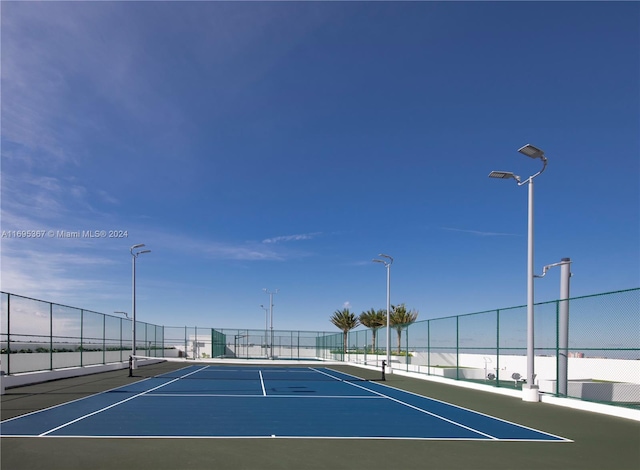 view of sport court with a water view